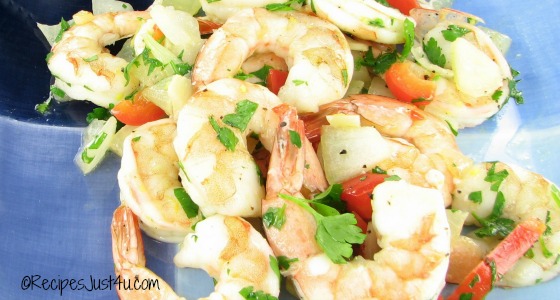Garlic lemon roasted shrimp on a blue plate, garnished with parsley.