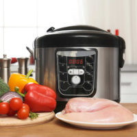 Slow cooker with chicken and vegetables.