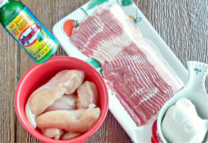 Bown of chicken tenders with bacon, cream cheese and hot sauce.