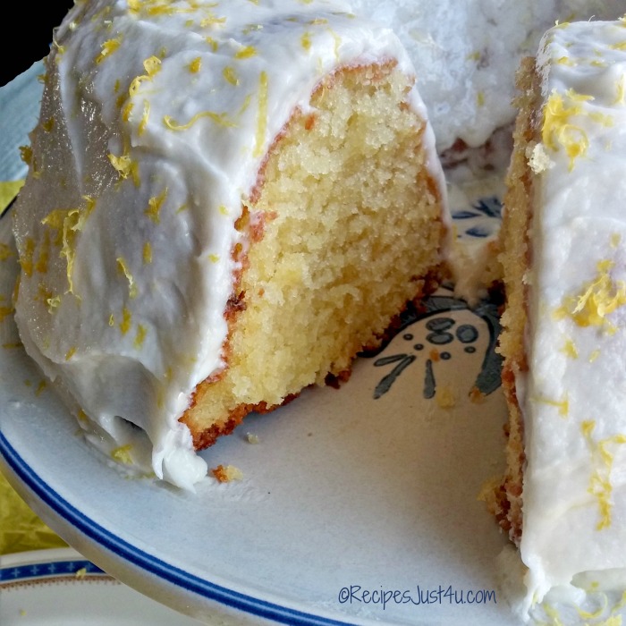 Lemon pudding bundt cake on a blue and white serving plate.