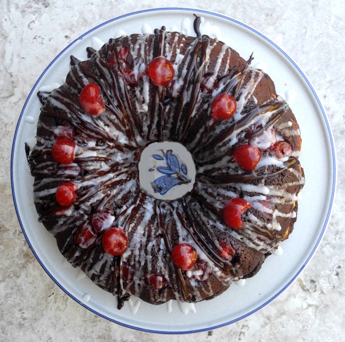 Drizzle the Chocolate Cherry Cheesecake Bundt Cake with two different glazes