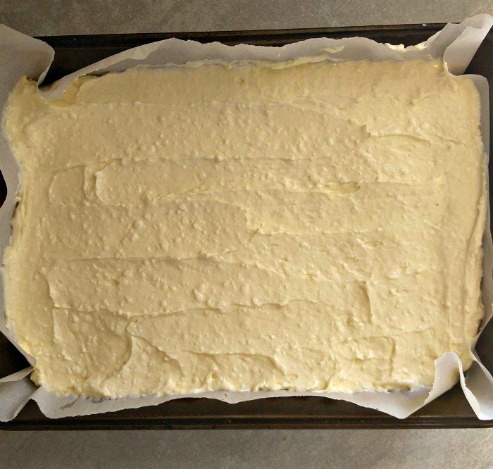 Spread the cheesecake layer over the cooked crumb crust.