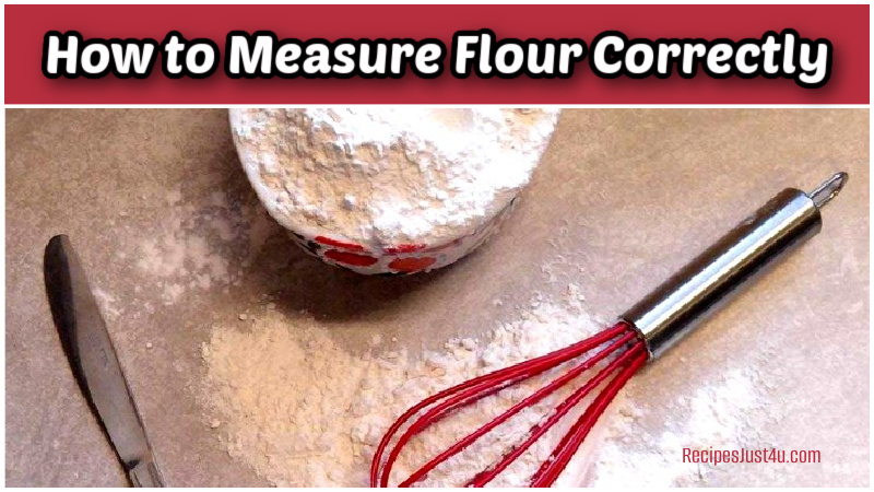 A picture of a whisk, knife and cup with flour in it, surrounded by loose flour.