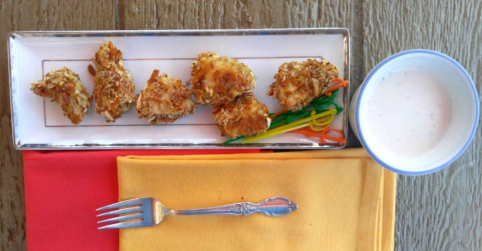 Pretzel crusted chicken bites on a plate.