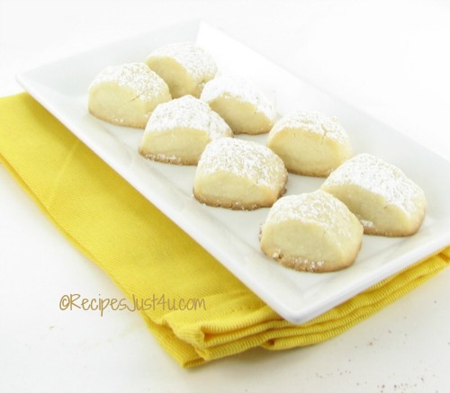 melting moment cookies on a white plate with yellow napkin.