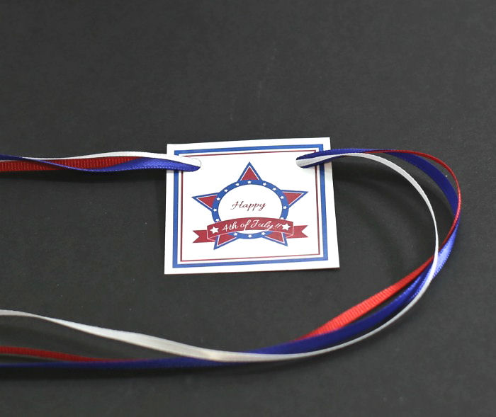 Red white blue ribbons on a 4th July label