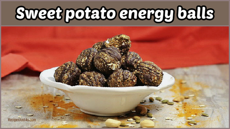 Sweet potato energy balls in a white bowl in front of an orange napkin next to some raw nuts.