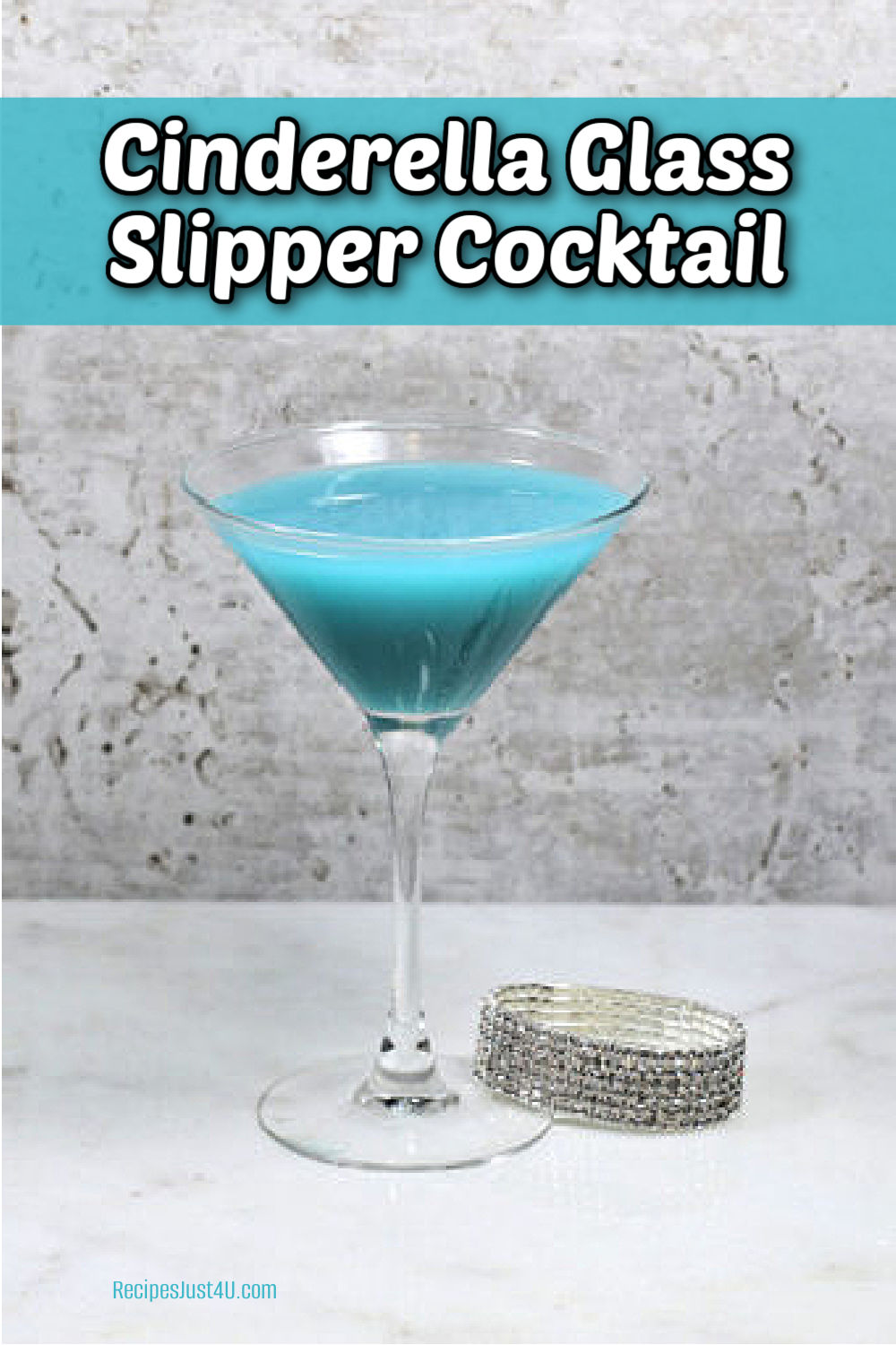 Blue Cinderella glass slipper cocktail next to a rhinestone bracelet.