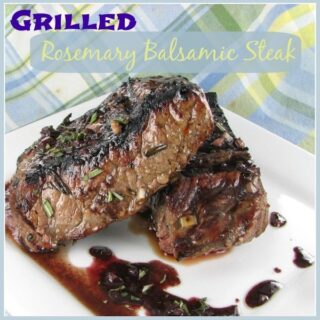 A white plate with two pieces of balsamic rosemary steak with rosemary balsamic steak marinade drizzles on them, with a plaid napkin in the background.