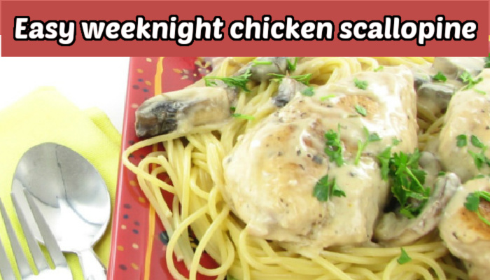Chicken scallopine on a red plate with a fork and spoon.