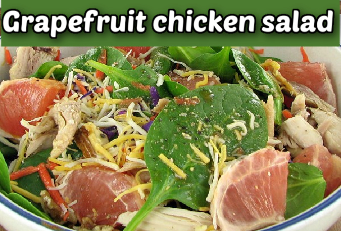 A grapefruit chicken salad with walnuts in a white bowl.