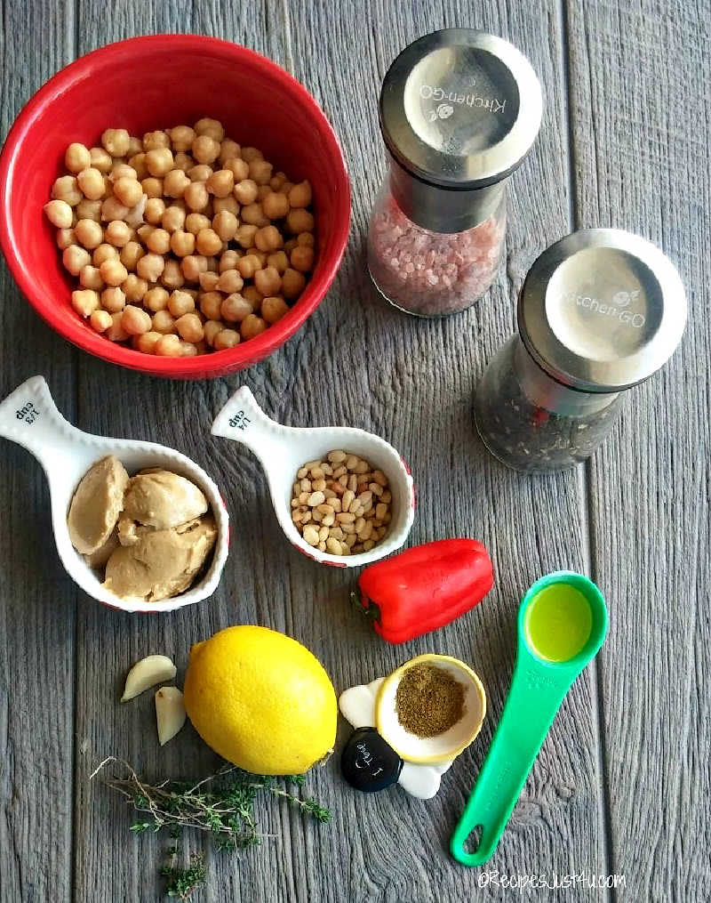Ingredients for pine nut hummus - chick peas, salt and pepper, garlic, pine nuts, lemon, cumin, oil, thyme, and red peppers.