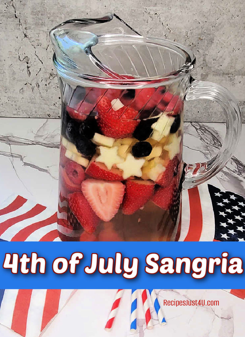 4th of July sangria in a tall picture with patriotic napkins and a flag.