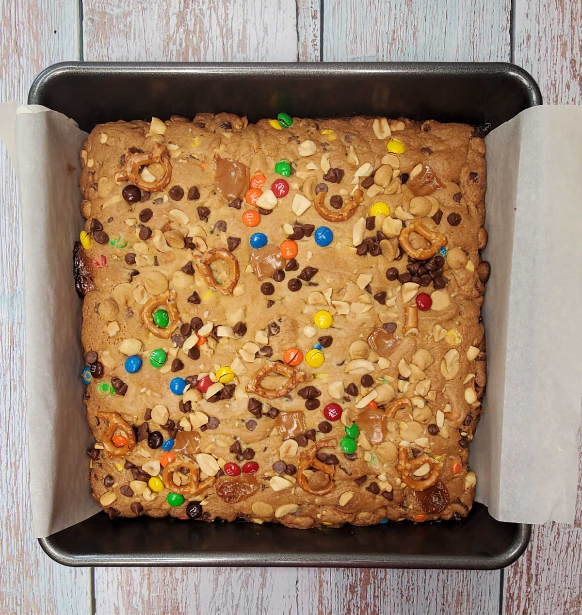 Baked kitchen sink cookie bars in a square baking pan.