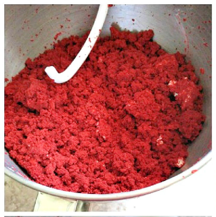 Red velvet truffle balls batter in a mixing bowl with a dough hook.
