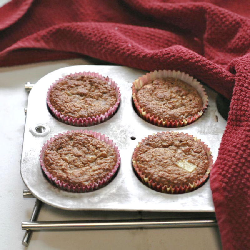Cinnamon apple muffins in a muffin pan.
