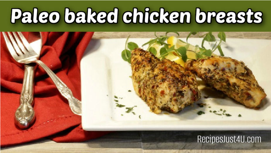Herb-crusted baked chicken on a white plate next to a red napking, fork and knife. Green text reads Paleo baked chicken breasts.