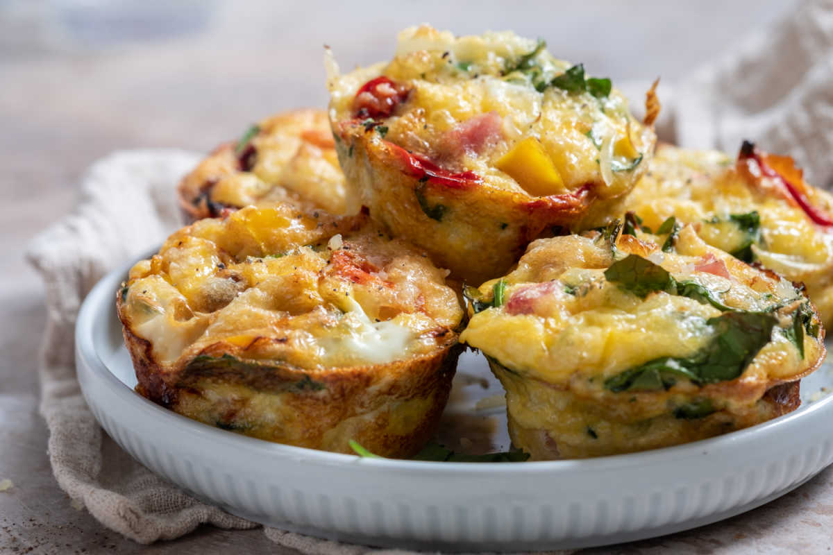 Spicy egg muffins with jalape&ntilde;o peppers in a white bowl.