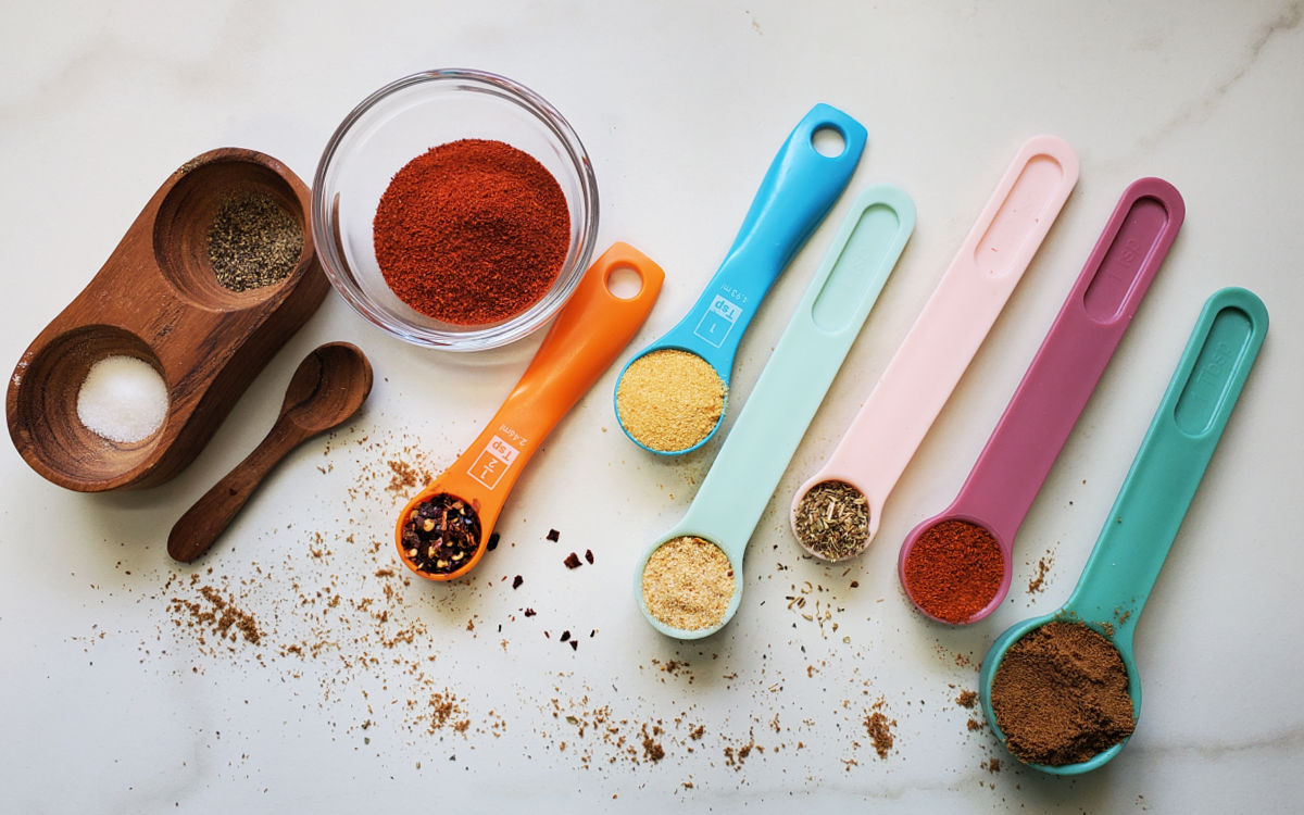 Bowls and spoons of spices to make taco seasoning for Mexican lettuce wraps